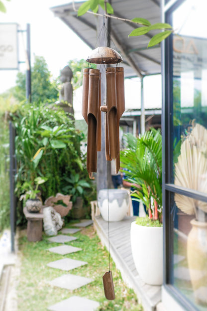 Elegant bamboo wind chimes swaying in the wind, adding a calming touch to an outdoor space.